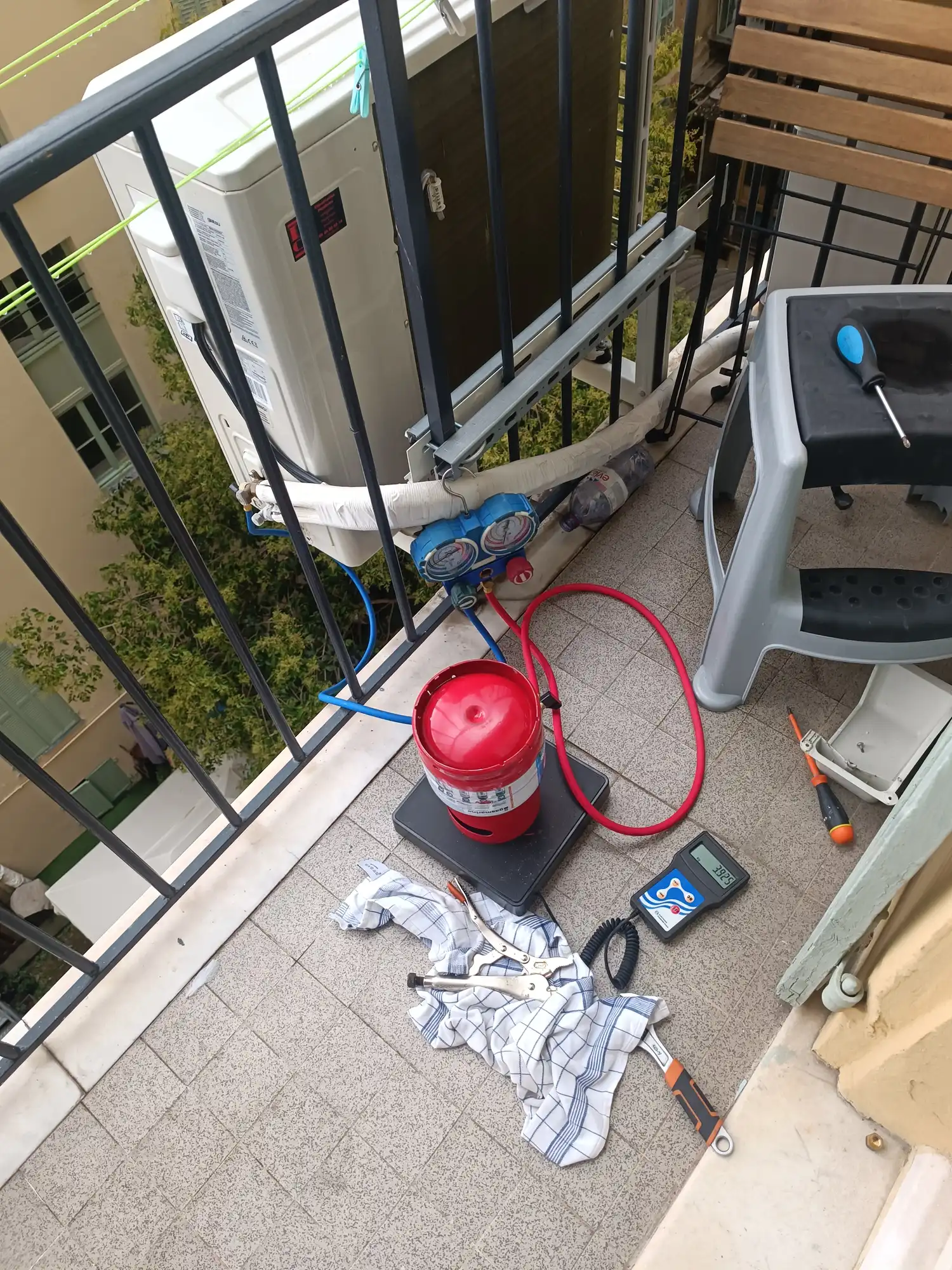 Air conditioning troubleshooting intervention in Nice Centre - Technician with tools on balcony