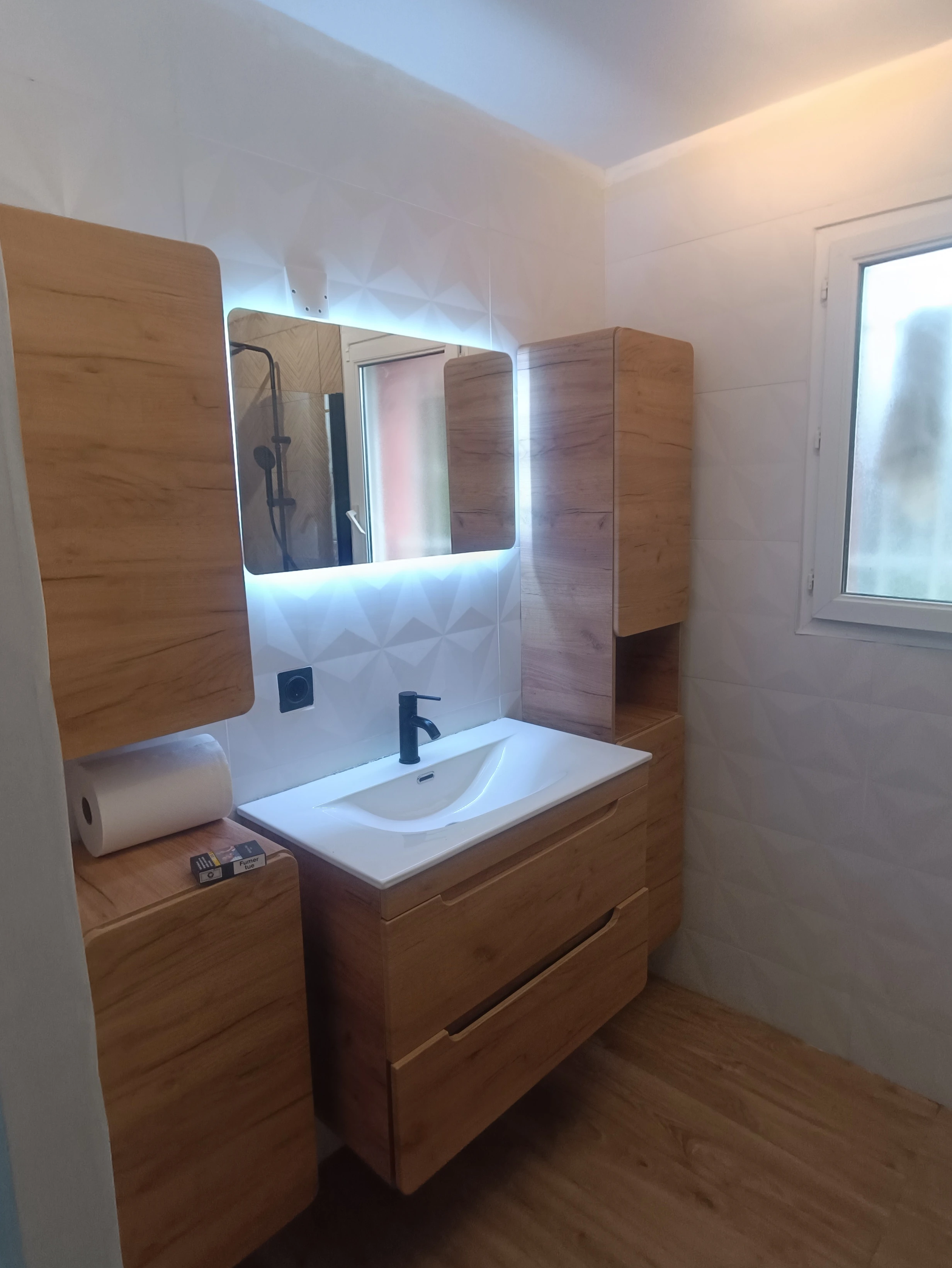 Installation of modern vanity unit and LED mirror in bathroom in Nice Centre